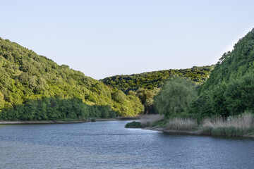 A lake in the shade of the hills.