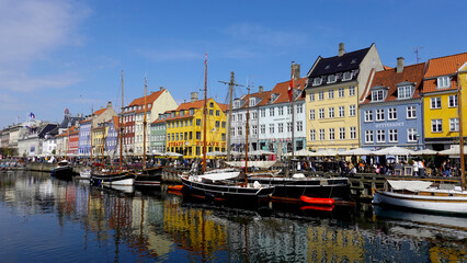 COPENHAGEN, DENMARK, APRIL 27, 2024: Copenhagen iconic view. The popular Nyhavn port area with the colorful houses in the center of Copenhagen, Denmark during spring season sunny day