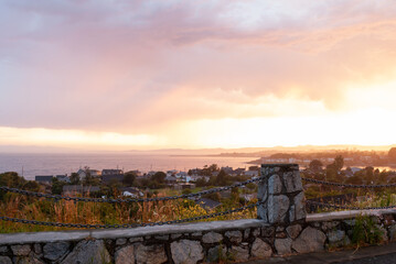 Golden sunset from a hillside overlooking city and water of Victoria BC