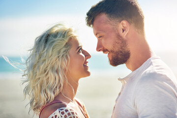 Happy, couple and sunshine on beach with love for seaside romance, serene holiday and ocean with...