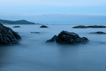 Mist like shore scene of the Pacific Ocean among the rocky shore of Vancouver Island seen at twilight. 
