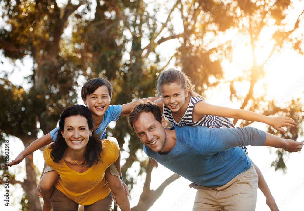 Wall mural Portrait, family and piggyback children at park for love, care or bonding together in nature. Mother, father or carry kids at garden for airplane game, support or happy parents play on summer holiday