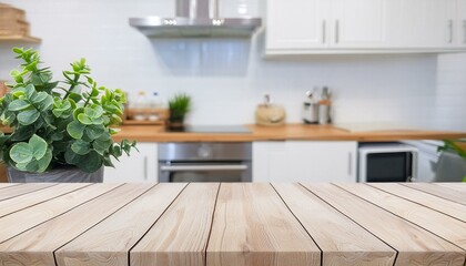 Fototapeta premium Wood table top with green plants on blur kitchen counter (room)background.