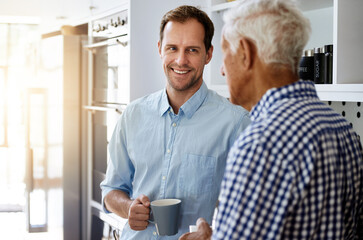 Happy, man and senior father in kitchen with conversation in morning with coffee for bonding in...
