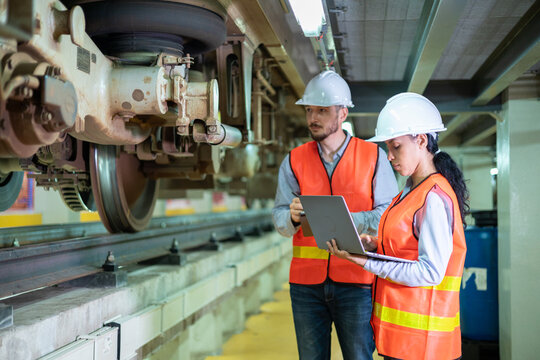 Engineers inspect the suspension wheels of electric vehicles, brake systems, and maintain equipment to be ready for use. - Powered by Adobe