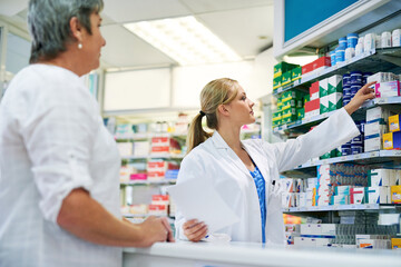 Pharmacist, shop and help customer with medicine, pills or drugs on shelf for healthcare. Pharmacy,...