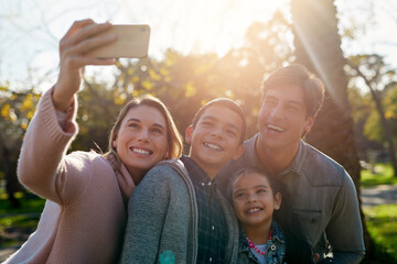 Happy, family and selfie at park together for love, laughing or bonding on summer holiday vacation. Smile, father and picture of kids with mother outdoor at garden for funny memory on social media
