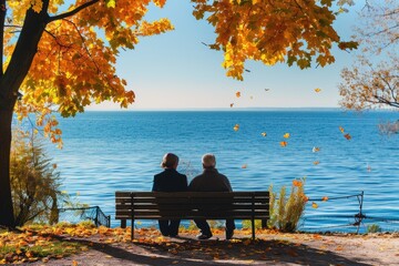 Senior couple sitting on bench near lake in sunny autumn day.