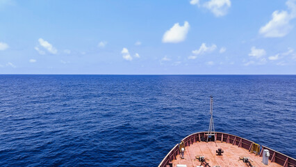 Ship sailing in blue sea in daytime. Top view of ocean.