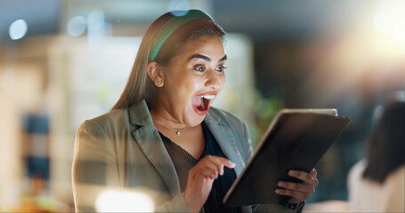 Fototapeta premium Night, tablet and wow with business woman in office for learning, reading or research. Internet, surprise and technology with excited professional employee in corporate workplace for email feedback