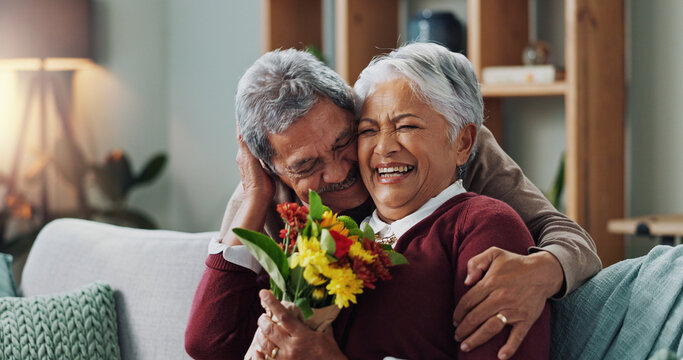 Couple, woman and old man with gift of flowers on sofa or couch, happy and living room of house. Senior, male person and partner with surprise for love, smile and happiness in home and retirement - Powered by Adobe