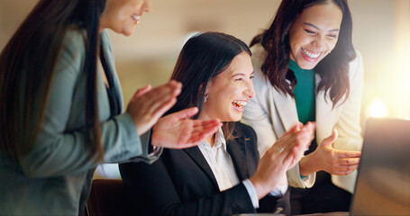 Corporate, business women and clapping in office for success, congratulations or celebration with laptop. Applause, winning and happy employees for company target, promotion or achievement at night