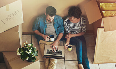 Box, laptop and couple with coffee in new home for real estate, property website or investment....