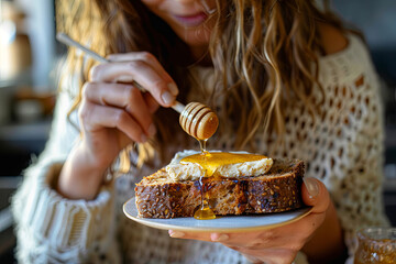 A woman, in a moment of tranquility, spreads honey on a slice of cricket bread, enjoying a sweet and sustainable break