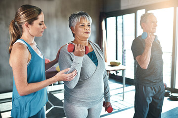Physical therapy, dumbbell and senior people in support, help and muscle workout for recovery or...