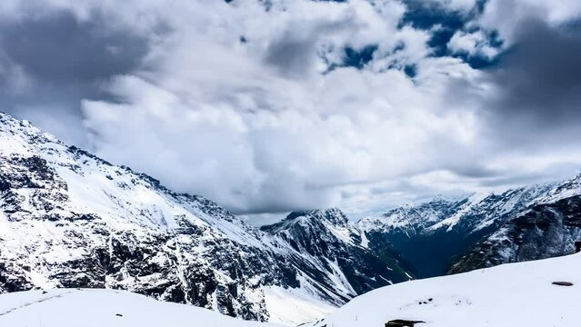 Beautiful timelapse of snow cladded mountain tops with clouds flying over in Rupin pass trek, Uttrakhand, India