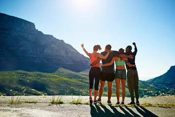 People, friends and mountain exercise with hands up victory from back for winning, achievement or...