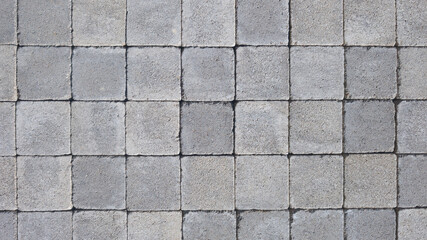 gray abstract pattern background of grey red cobblestone pavement in close-up top view