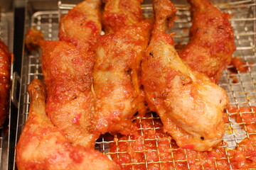 Fried chicken wings on the stove in the market