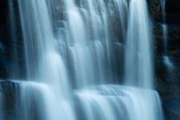 abstract silky water flowing on cold rocks