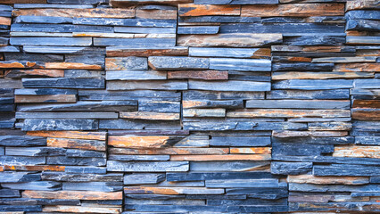 The old vintage gray blue and brown natural stone slate wall texture background