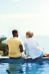 Couple, poolside and conversation to relax in outdoor, bonding and together for love or talking. People, back and speaking on holiday or vacation, alcohol and trees or sky mockup for peace and calm