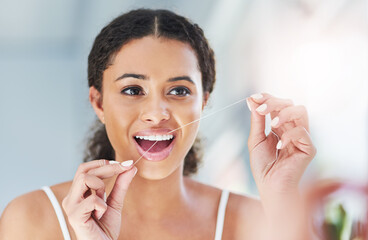 Woman, floss and dental hygiene in bathroom for health, wellness and cleaning teeth in home. Female...