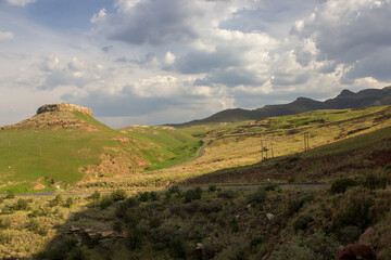 Late afternoon view over the Afroalpine grasslands of the Golden Gate Highlands National Park in the Drakensberg Mountains, South Africa, with the distant peaks in shadow