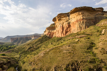 Late afternoon view over the main section of the Golden Gate Highlands National Park, South Africa, with the mushroom rock, one of the iconic mountains of the park in the foreground