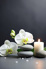 Fototapeta na wymiar Zen stones, candles and white orchid flower on green and grey background