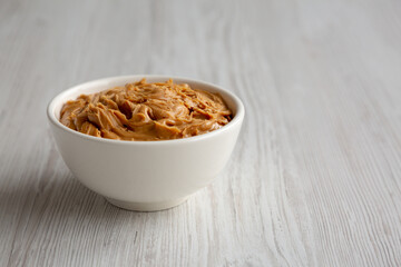 Organic Raw Peanut Butter in a Bowl, side view.