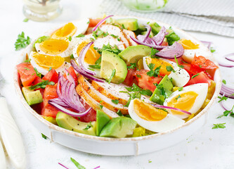 Healthy cobb salad with chicken, avocado, tomato, red onions and eggs. American food.