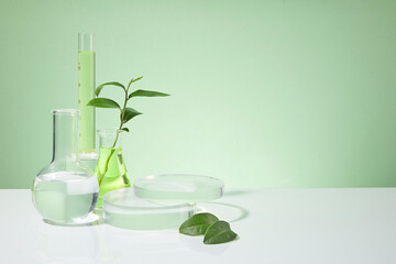 Light green background featured some lab glassware placed on white table top consist of boiling...