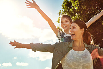 Playing airplane, girl and mom in outdoor park with blue sky for game, fun and bonding together....