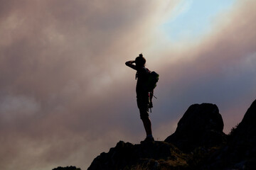 Hiker observing atop of Roc'h Bichourel the fire in the Monts d'Arrée