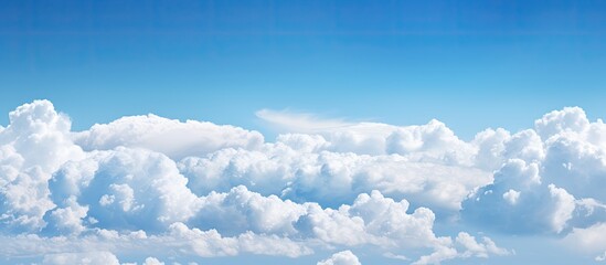 A background image with a clear blue sky and fluffy clouds has a copious amount of copy space for you to utilize