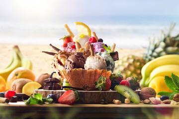 Assorted fruit ice-cream on wooden table on the beach