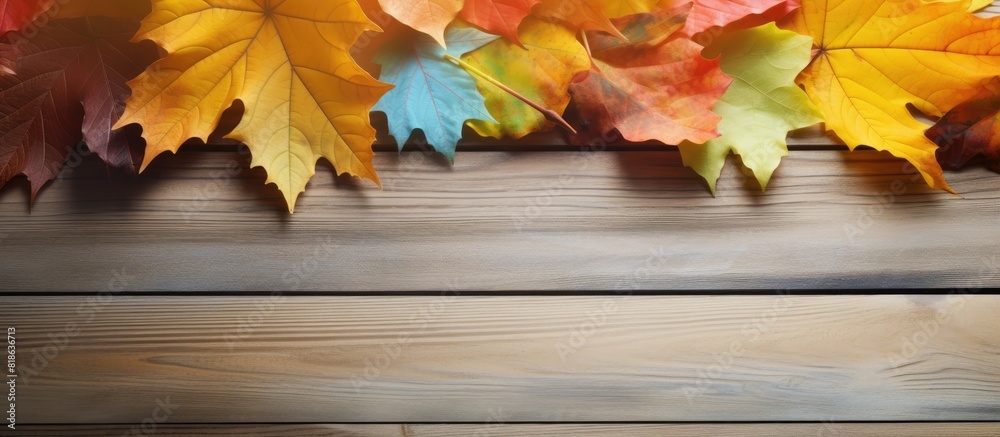 Poster There is a copy space image of colorful autumn leaves resting on a wooden table
