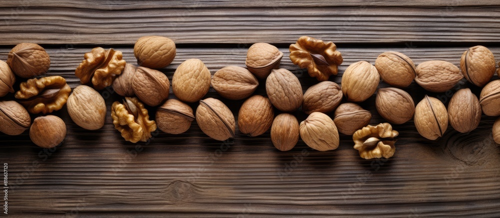 Poster a close up copy space image of walnuts scattered on a wooden background