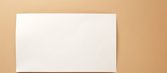 Beige background with a white blank sheet of paper for copy space image