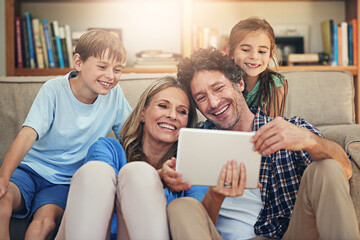 Happy family, relax and watching movie with tablet for online entertainment or streaming service at...