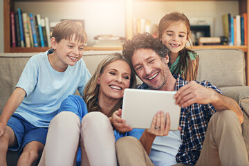 Happy family, relax and watching movie with tablet for online entertainment or streaming service at home. Mom, dad or children with smile on technology for show or series on living room sofa at house