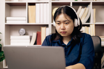Online academy, student and woman conduct research on their laptops, people work on desktops in...