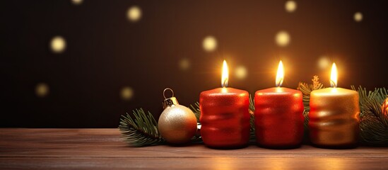 A copy space image featuring four flickering candles against the backdrop of a Christmas tree