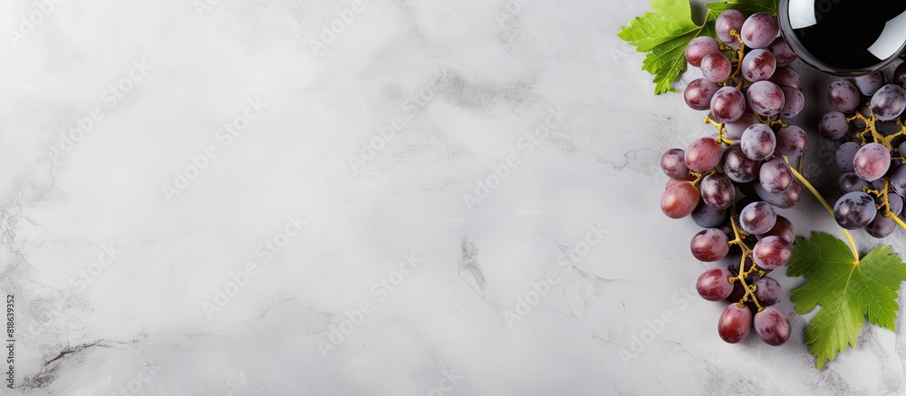 Fototapete A top view of wine and grapes on a grey marble background with ample copy space for additional elements or text