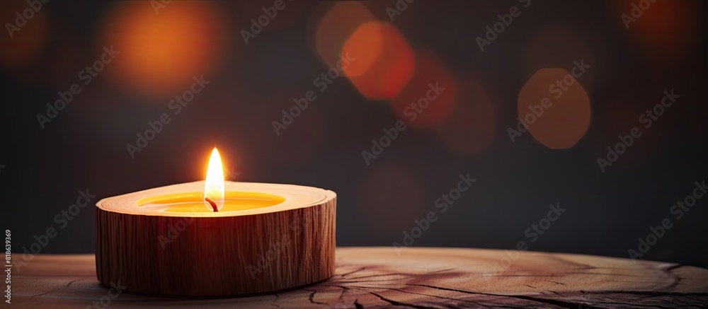 Leinwandbilder a wooden top with a lit candle on it creating a warm and cozy ambiance a copy space image to be used