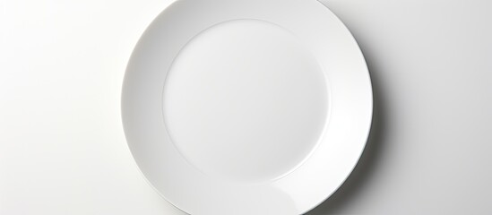 A high quality photo featuring a white round plate placed on a white background with ample copy space image