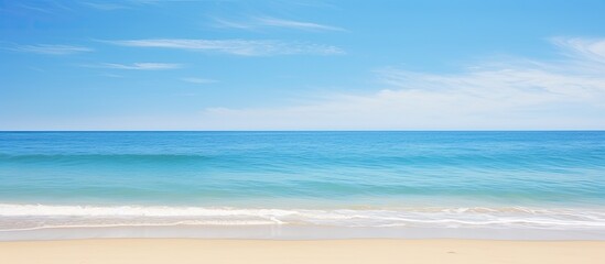 Clean beach at daylight with a stunning panoramic seascape featuring a clear blue sky offering copy space
