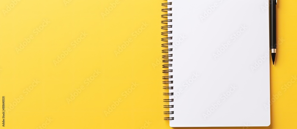 Leinwandbilder an isolated yellow background with a white open notepad provides plenty of copy space image