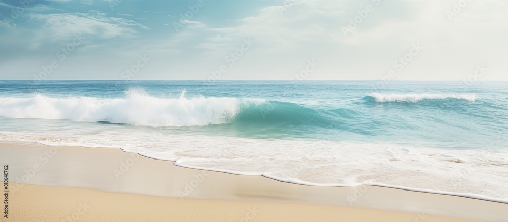 Poster a tropical beach with blurred waves and sand in the foreground offers plenty of copy space for your 